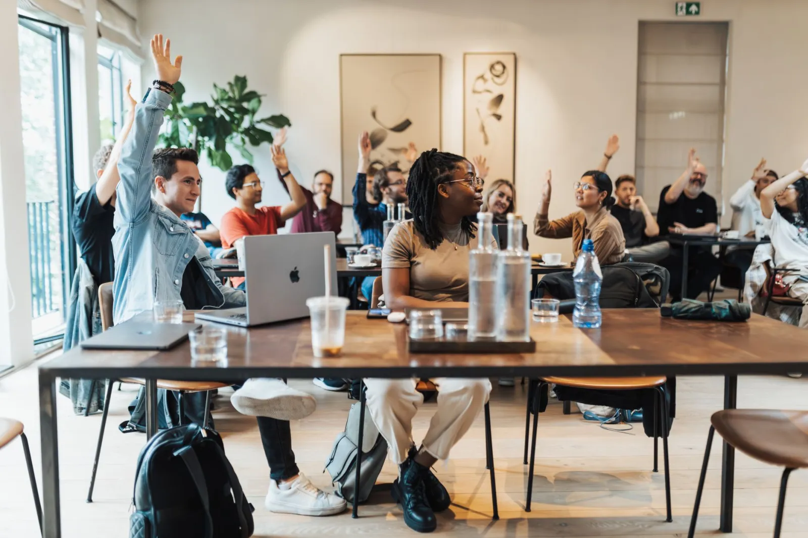 A diverse group of adults participating in an interactive workshop session indoors.